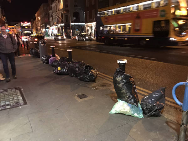 Photo of bags on a footpath.